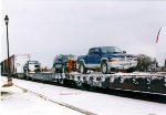 These Trucks on the flat cars  will make the trip to Moosenee